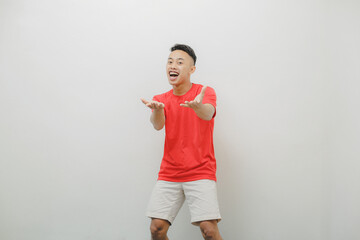 a young man wearing a red shirt on a white background with a cheerful expression