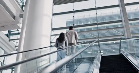 Business people, luggage and airport escalator for walking, global travel and international flight schedule in New York. Businessman, woman and suitcase on stairs, back and hotel for working holiday