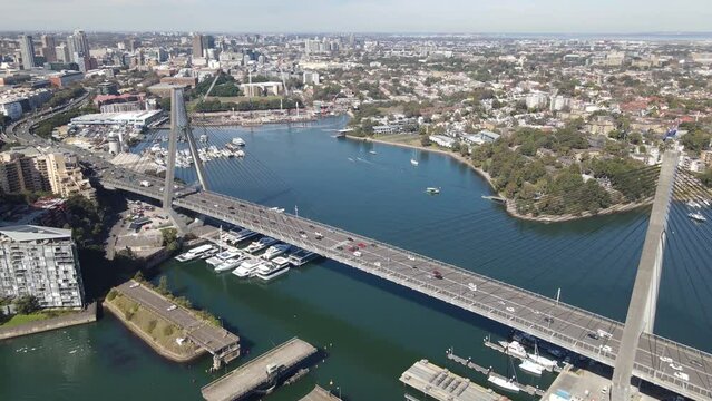 Aerial drone view of Anzac Bridge across Johnstons Bay between Pyrmont and Glebe Island in Rozelle, Sydney NSW on a sunny morning  