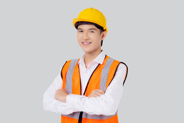 Portrait engineer young asian man wearing helmet standing and smiling with confident isolated on white background, handsome male is architect or contractor arms crossed, industrial concept.