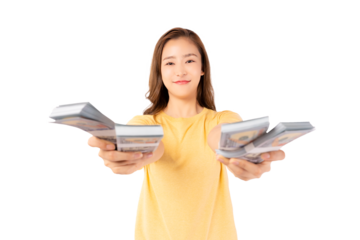 Happy young asian woman holding money banknotes and celebrating isolated over yellow background Happy asian lady showing money dollars and Smiling satisfied girl earning a lot of money She give money
