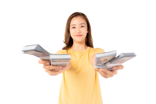 Happy young asian woman holding money banknotes and celebrating isolated over yellow background Happy asian lady showing money dollars and Smiling satisfied girl earning a lot of money She give money