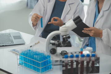 Team of Scientists Choose Between Printed Circuit Board to Work With. In The Background...