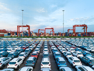 Aerial view new car lined up in the port for import and export business logistic to dealership for sale, Automobile and automotive car parking lot for commercial business industry. - 634255850