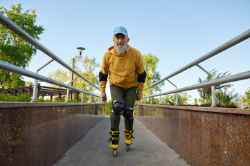 Brave senior man moving fast on roller skates outdoors