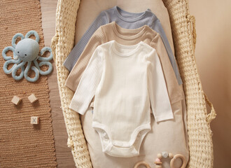 newborn baby rompers in moses basket, nautical theme 