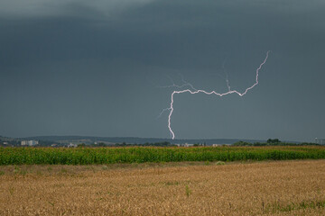 Remarkably shaped lightning discharge over the countryside at daytime