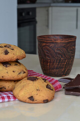 in the kitchen there is a cup of coffee and cookies on the table