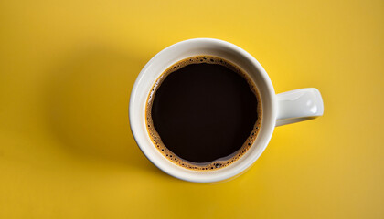 Black coffee in a cup on a yellow background