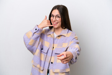 Young girl isolated on white background making phone gesture and pointing front