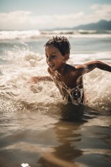 cropped shot of a young boy splashing around in the ocean