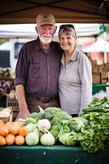 Fototapeta premium portrait of a happy couple standing in front of their produce stall at a farmers market