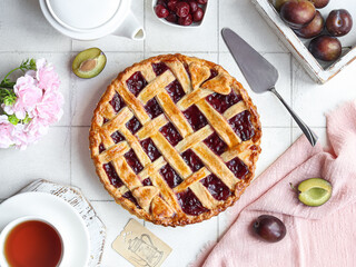 Cherry pie with lattice crust on table.