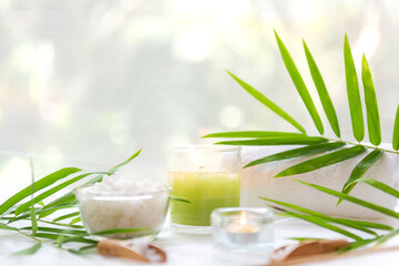 Thai Spa Treatments aroma therapy salt and  sugar scrub massage with bamboo leaves with candle, white background. Thailand. Healthy Concept