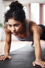 Fototapeta premium cropped shot of a young woman working out on an exercise mat