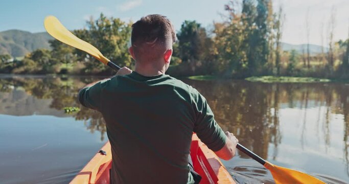 Kayak, river and back view of man on an adventure to explore the water by rowing while camping in nature. Boat, canoe and person in a lake for vacation or holiday in the countryside for freedom