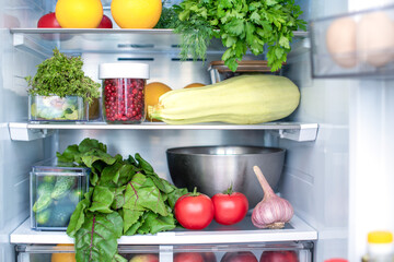 Open fridge full of fresh fruits and vegetables, vegetarian food healthy food background, greenery, organic nutrition, health care, dieting concept.