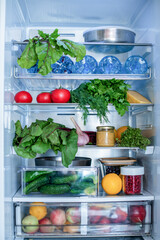 Open fridge full of fresh fruits and vegetables, vegetarian food healthy food background, greenery, organic nutrition, health care, dieting concept.