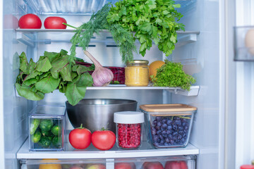 Open fridge full of fresh fruits and vegetables, vegetarian food healthy food background, greenery,...