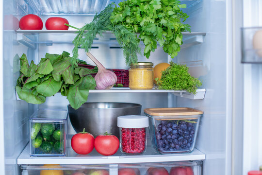 Open fridge full of fresh fruits and vegetables, vegetarian food healthy food background, greenery, organic nutrition, health care, dieting concept.