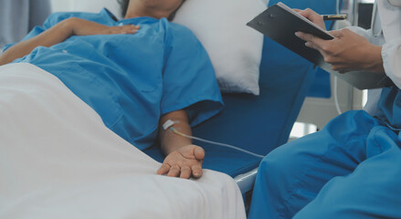Young doctor is using a stethoscope listen to the heartbeat of the patient. Shot of a female doctor...