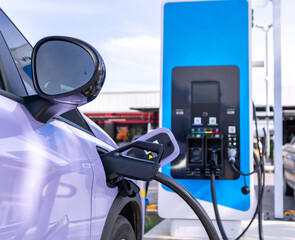 Electric cars parked for charging at power stations.