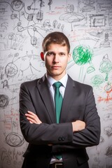 a handsome businessman standing in front of a whiteboard with various business ideas drawn on it