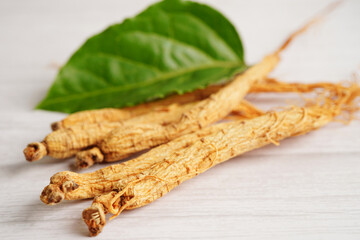 Ginseng roots and green leaf, healthy food.