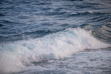 Sea abstract or rippled water texture background. Calm water surface texture with splashes and waves. Abstract nature background. Surface of blue ocean water.
