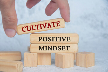 Cultivate positive mindset text on wooden blocks. Continuous improvement concept