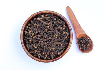 Dried Cloves in a wooden bowl on white background top view 