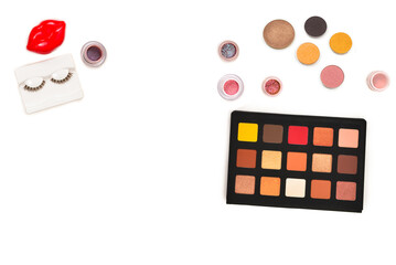 Professional makeup products with cosmetic beauty products, eye shadows, pigments, lipsticks, brushes and tools. Space for text or design.
