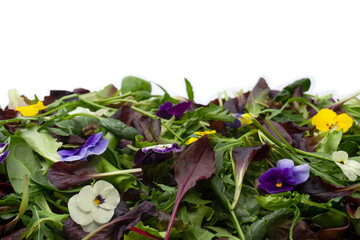 Fresh mix of salads with edible flowers. Top view.