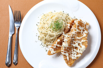 deep fried crispy fish fillet chips with fried egg, French fries, coleslaw salad, in tartar sauce carbonara pasta on brown leather white background western chef halal food restaurant banquet menu cafe