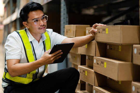 Logistics And Export Business Concept. Warehouse Manager Uses A Tablet Computer To Inspect Goods In A Warehouse.