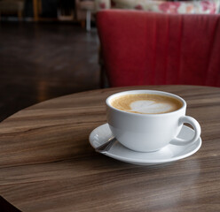 Coffee Cup on circle Wooden Coffee Shop Table  in coffee shop