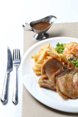 grilled golden bbq chicken chop pork cutlet beef steak with fried egg, French fries, coleslaw salad and black pepper sauce on brown leather white background western chef halal food restaurant menu
