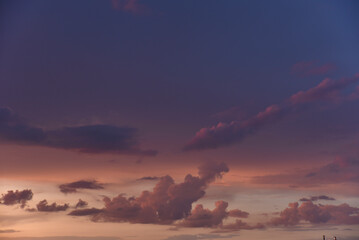 Fototapeta premium Pink clouds and evening sunset sky after a thunderstorm. Blue-red sunset evening. Beautiful pink clouds.