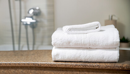 Obraz na płótnie Canvas Stack of white towels on table in bathroom