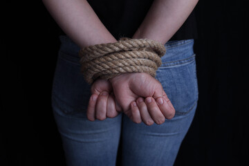 Woman with hands tied behind her back