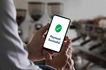 customer using a smartphone Online Money Transfer Confirmed at the cafe coffee Technology lifestyle payment screen a banking payment on a mobile phone