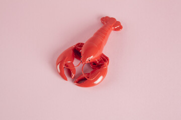 a red lobster on a pink background