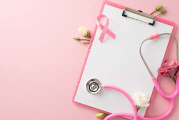 Concept of breast cancer awareness. High-angle top view of medical poll clipboard, pink ribbon symbol, stethoscope, eustoma flowers on pastel pink background with blank area for text or advertisement