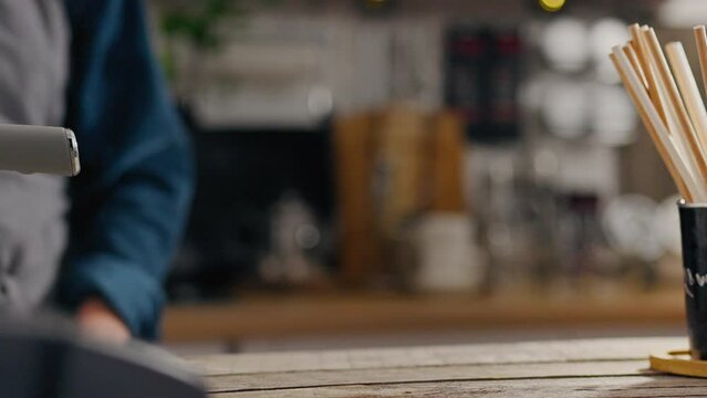 Cafe, barista serves coffee order to customer in restaurant. Tracking shot Bartender preparing coffee in the process of preparing coffee in the workplace uses different types of coffee Online shopping