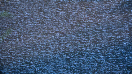 Water surface in heavy rain with shallow depth of field. Rain texture, water seething