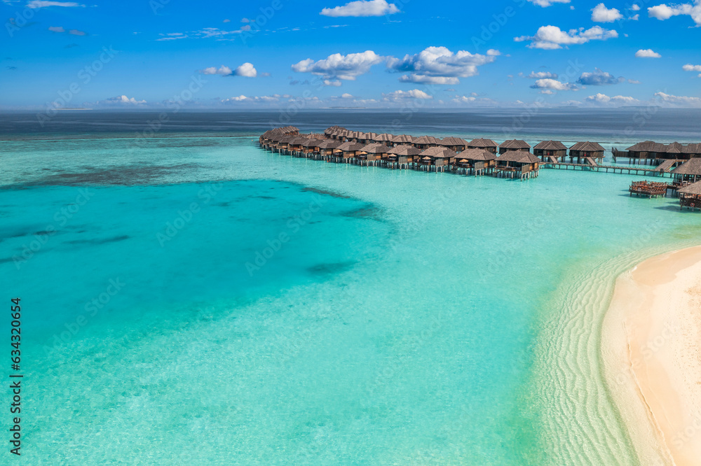 Canvas Prints Stunning aerial landscape, luxury tropical resort with water villas. Beautiful island beach, palm trees, sunny sky. Amazing bird eyes view in Maldives, paradise coast. Exotic tourism, relax nature sea