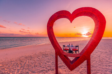 Honeymoon couples dinner at private luxury romantic dinner on tropical beach in Maldives. Seaside sea view, amazing island coast with red heart shape table chairs. Anniversary love destination dining - obrazy, fototapety, plakaty