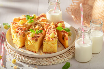 Homemade gooseberry butter cake served with milk in bottle.