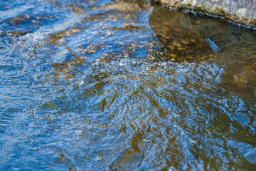 flow of water and spray from a stone