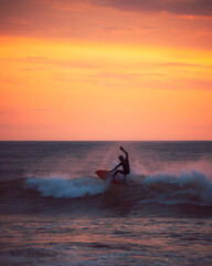surfer at sunset in Unstad Arctic Surf Lofoten Norway